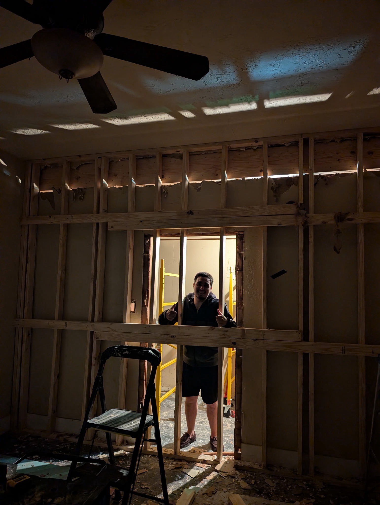 Wall removal in progress with framing and header installation underway